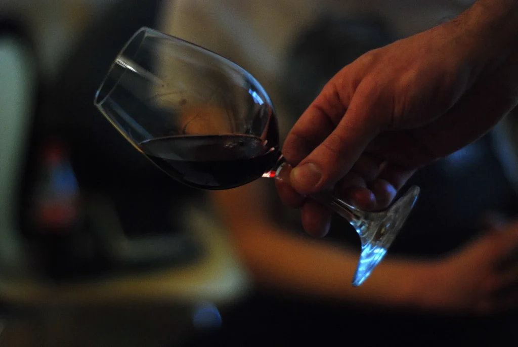 Hand holding a glass of red wine