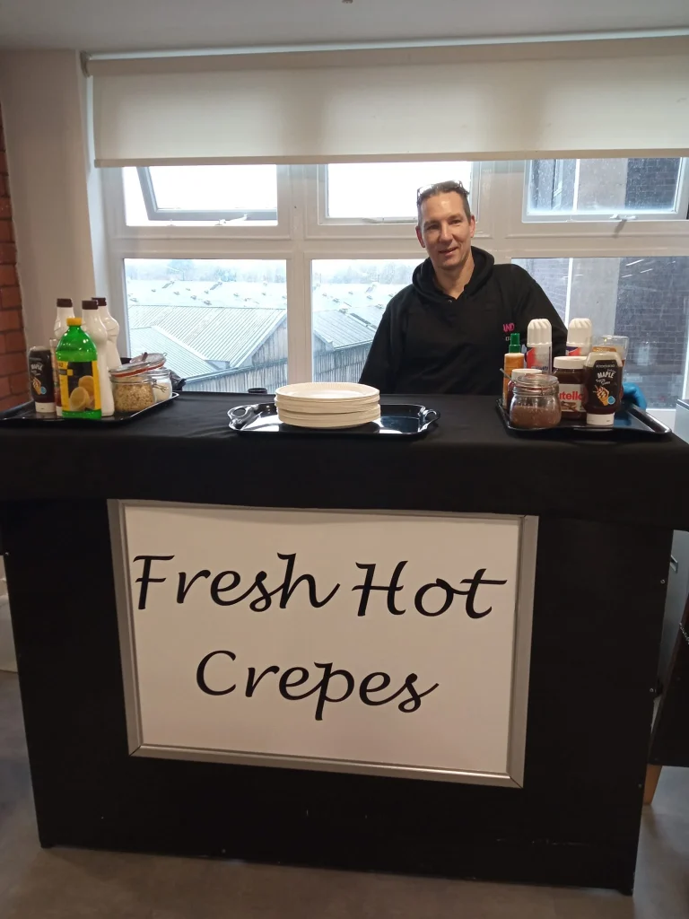 Fresh hot crepes station with a server