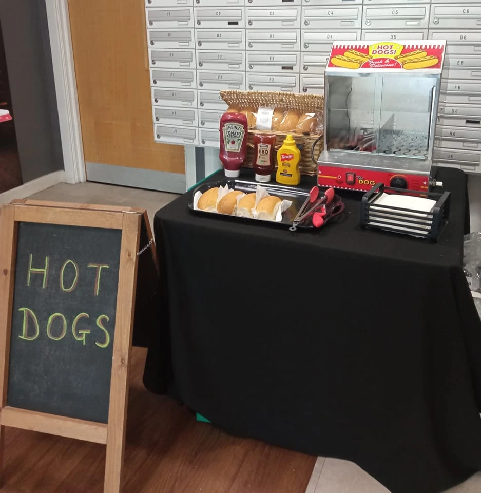 Hot dog stand set up with a chalkboard sign