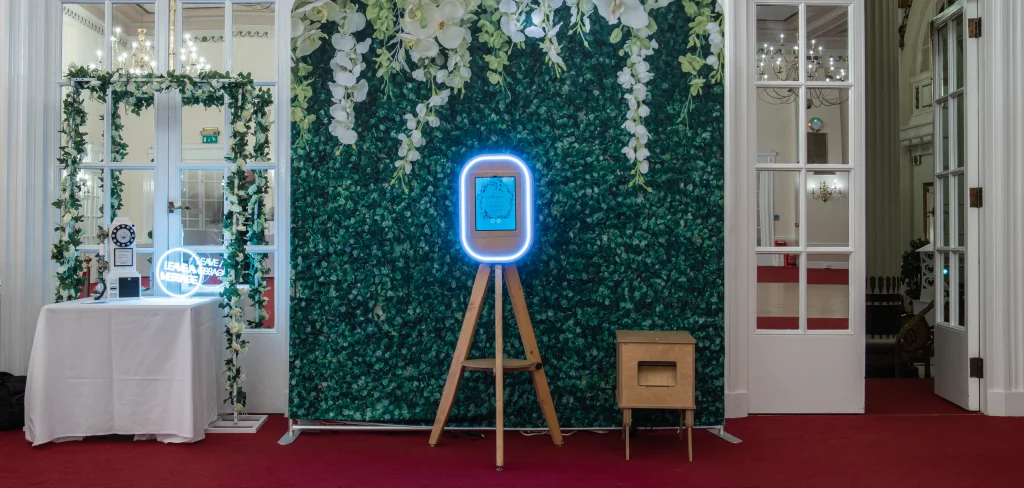 Audio guest book telephone beside a greenery wall