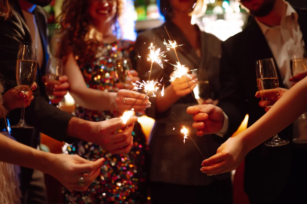 Guests holding sparklers and champagne