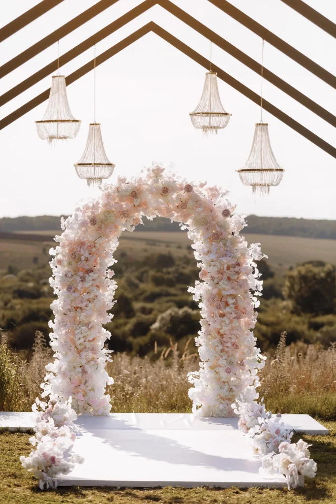 Wedding arch decorated with blush flowers