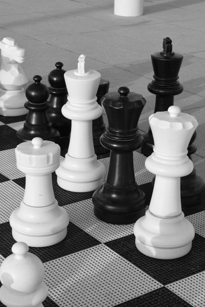 Giant chess pieces on an outdoor board
