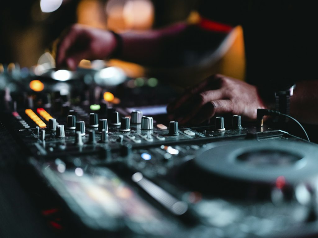 DJ mixing on decks at a party